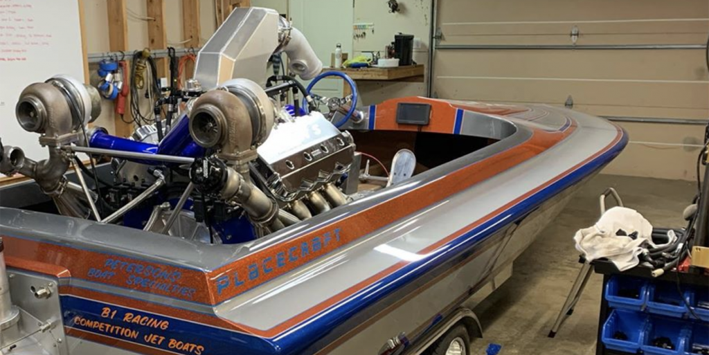 Two year old drives his own mini petrol powered speed boat. 