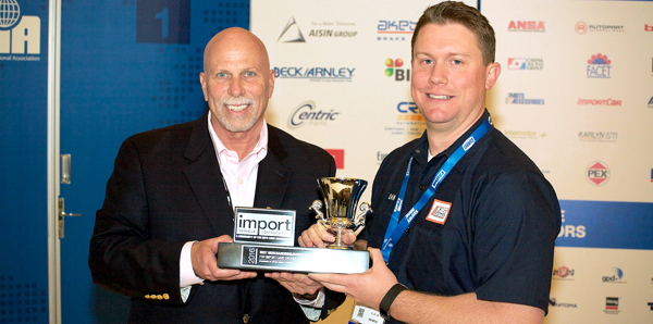 Dan Clarke (right), Permatex Senior Product Manager, accepts the 2016 Import Product and Marketing Awards for Best Merchandising/Advertising from Ira Davis (left), Chairman of the Import Vehicle Community.